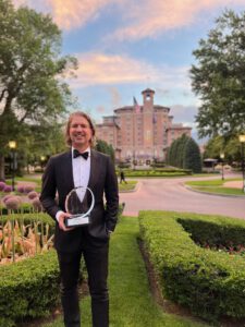 rich razgaitis holding an award
