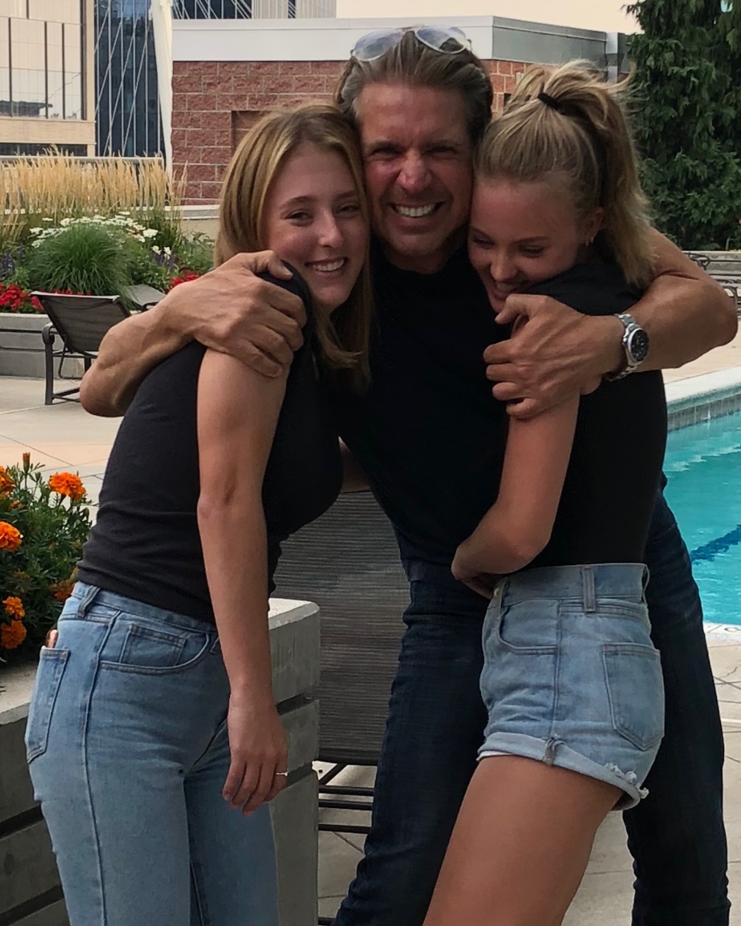 raz and his two daughters hugging